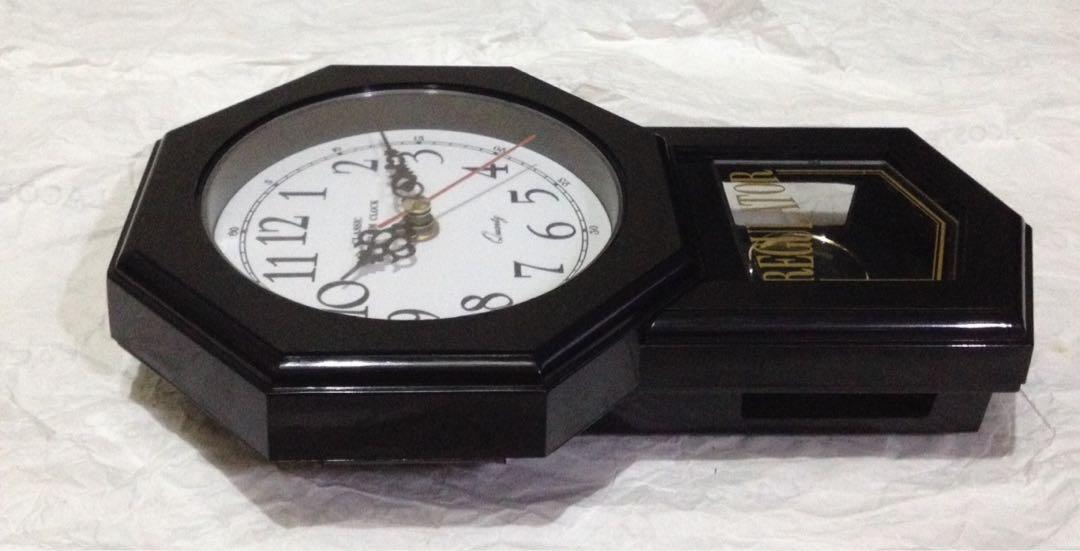 Classic Wall Clock With Pendulum (Category: Clocks) located in Makati City. Submitted by citromon_potpourri (Listing ID 188376395, Image 3). Description: Body made of thermoplastic, has a gold bezel, white face, black hands and numbers. Sweep mode second hand and pendulum movement. No Chime..
