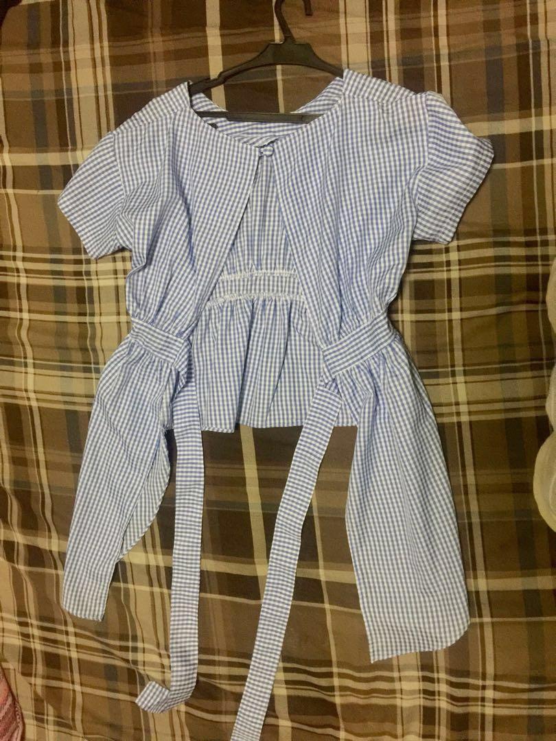 Blue Gingham open back blouse (Category: Blouses) located in Pasig City. Submitted by geejae (Listing ID 183005138, Image 2). Description: Cute blouse , with a twist . It’s sexy at the back ☺️ Long at the sides for added style and to emphasise figure. Tie back style , to leave something for the imagination 😀 Great when paired with boyfriend jeans and sneakers, but even better with shorts . * black shirt not included Good as new, worn ONCE ( hubb