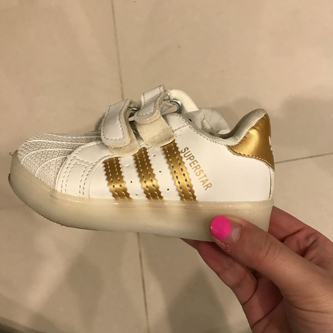 adidas white shoes with gold stripes