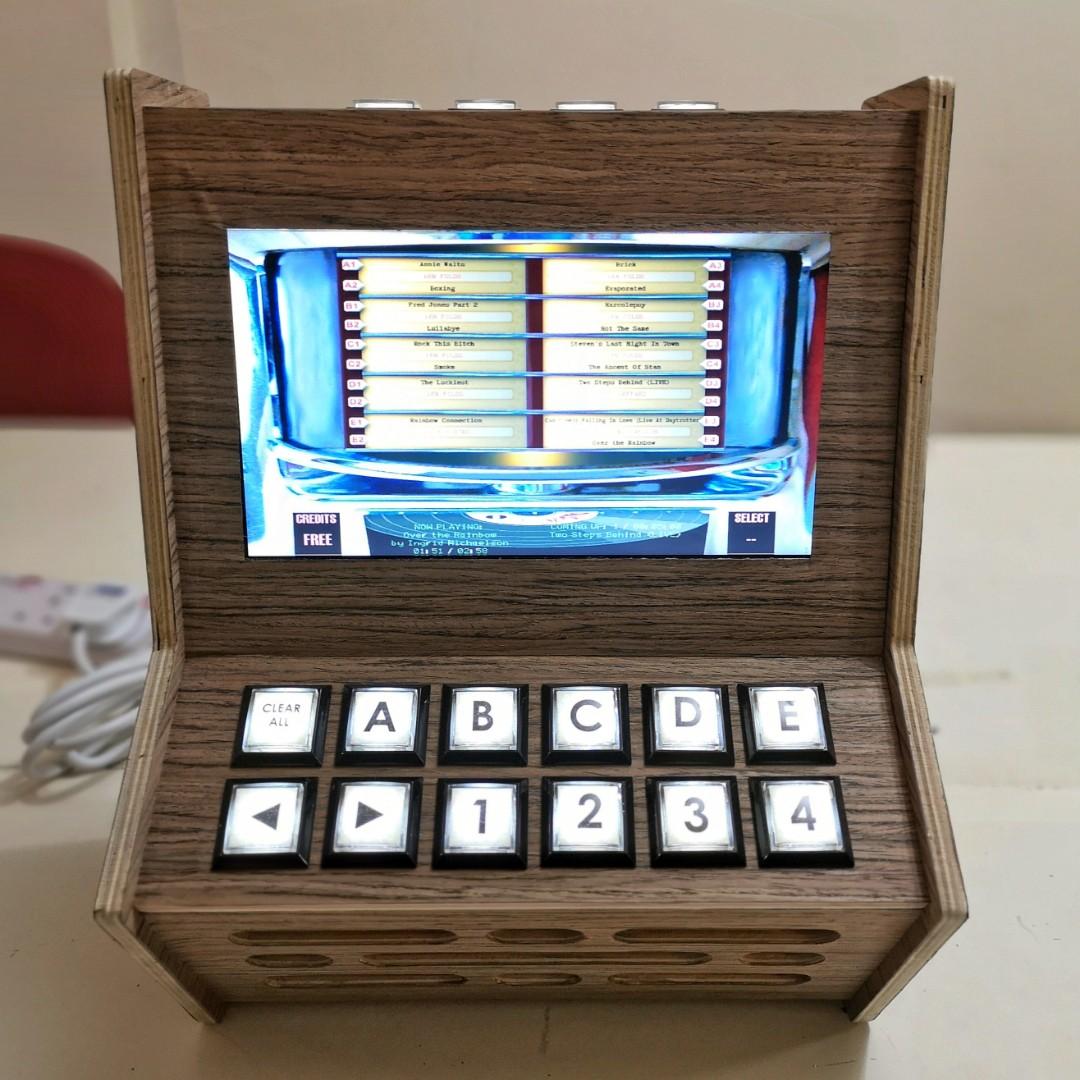 Jukebox (Category: Portable Music Players) located in Singapore. Submitted by retrocadesg (Listing ID 198501356, Image 3). Description: Handmade Digital Jukebox Buttons to replicate the feel of jukebox. The interface emulates jukebox of yesteryears. 10.1" LED screen 3w stereo speakers Plug in your thumbdrive for your own song library. Selection of wood finishing is available..