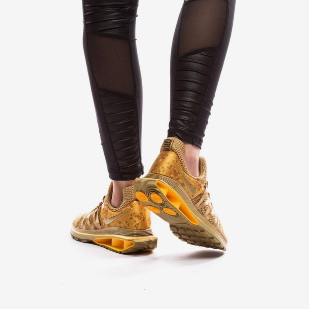 Nike shox gravity women's gold top