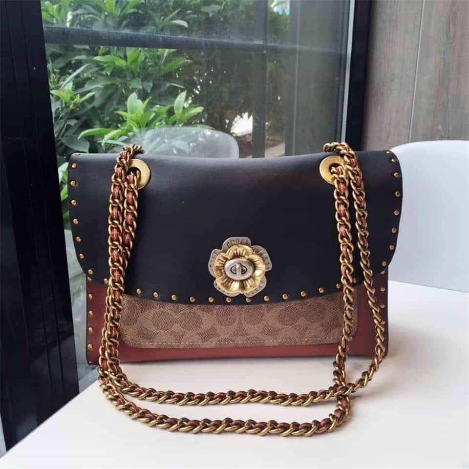 coach parker with rivets and snakeskin detail