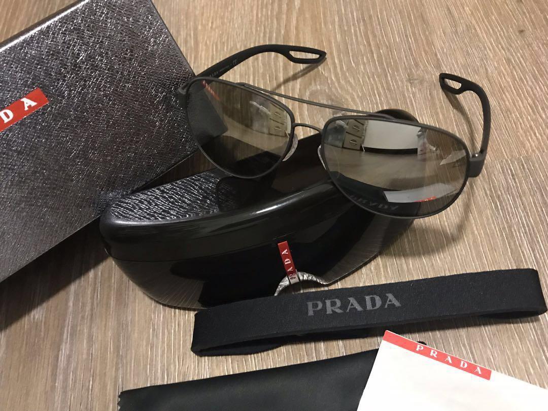 Authentic Prada Sunglasses (Category: Accessories) located in Kuala Lumpur. Submitted by s.mcmuffin (Listing ID 200034412, Image 2). Description: Good condition (for unisex) Matte design Free Sports Prada band that can be attached to sunglass No nego No fussy buyer Exclude postage.