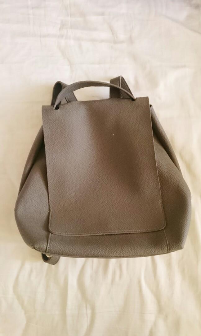 Gray Backpack (Category: Backpacks) located in Quezon City. Submitted by mallows23 (Listing ID 203620245, Image 1). Description: Gray backpack with magnetic clasp With detachable zippered pouch Used a few times Rfs: Too many bags.