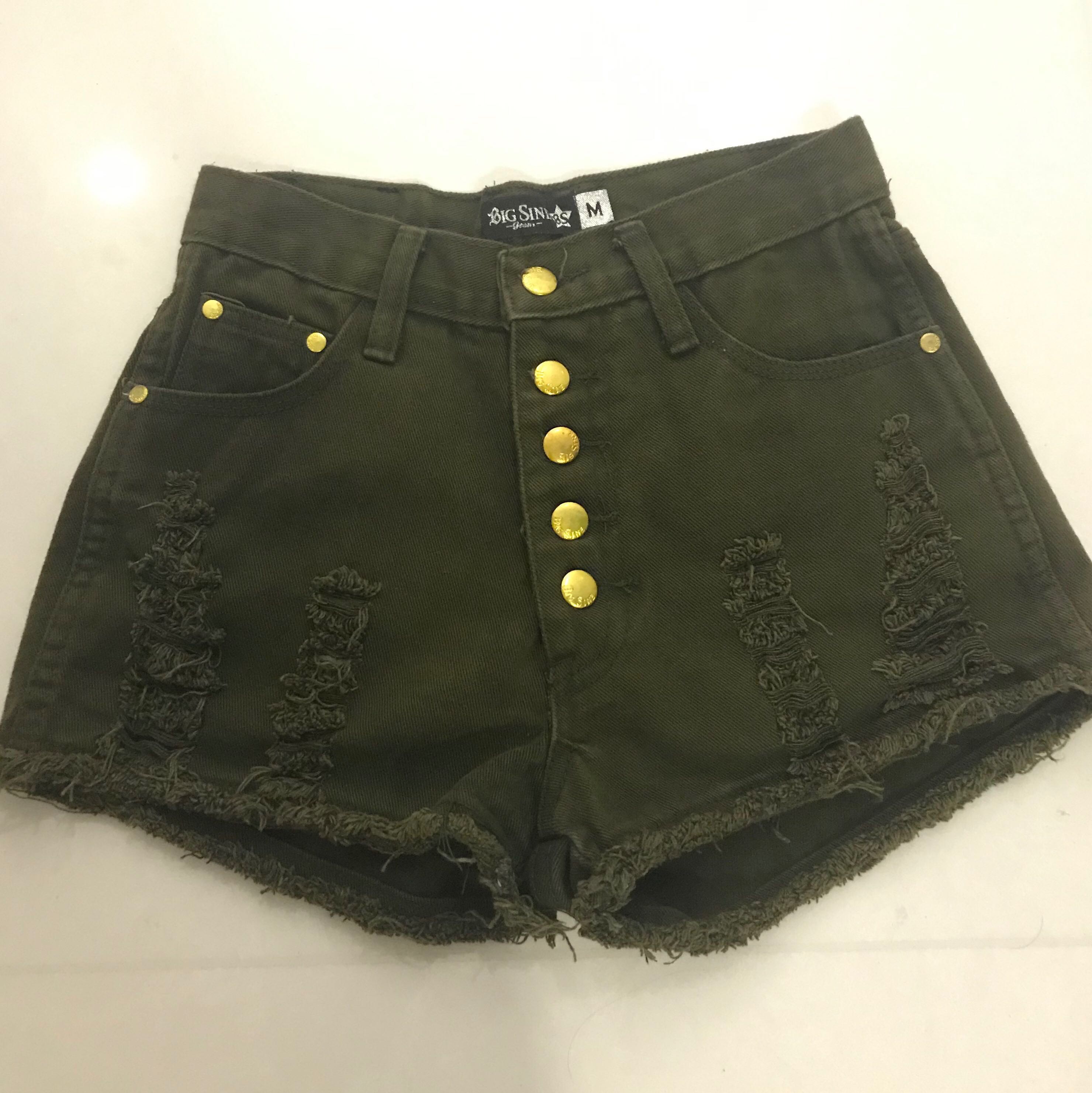 green ripped shorts