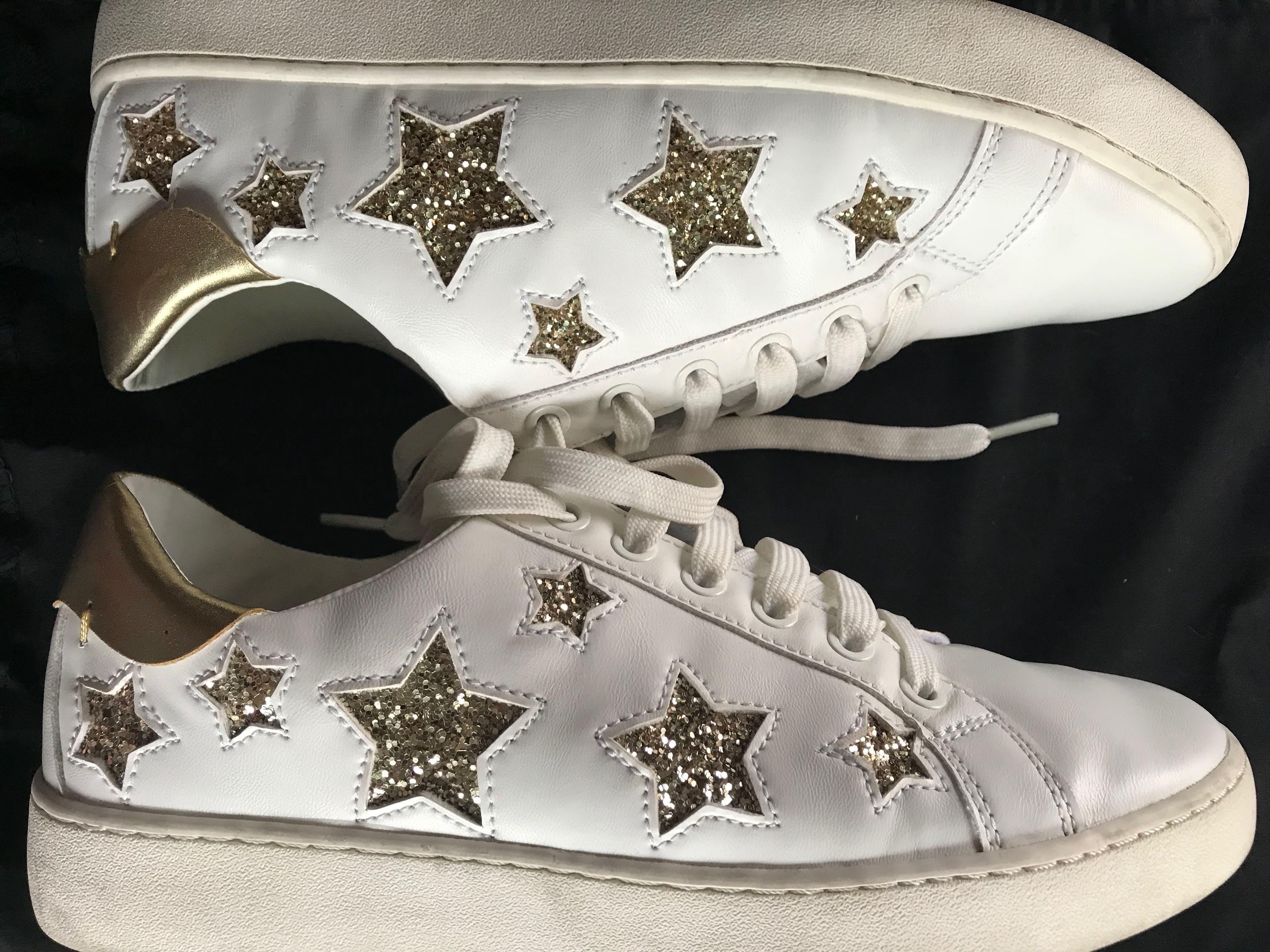 white sneakers with gold stars