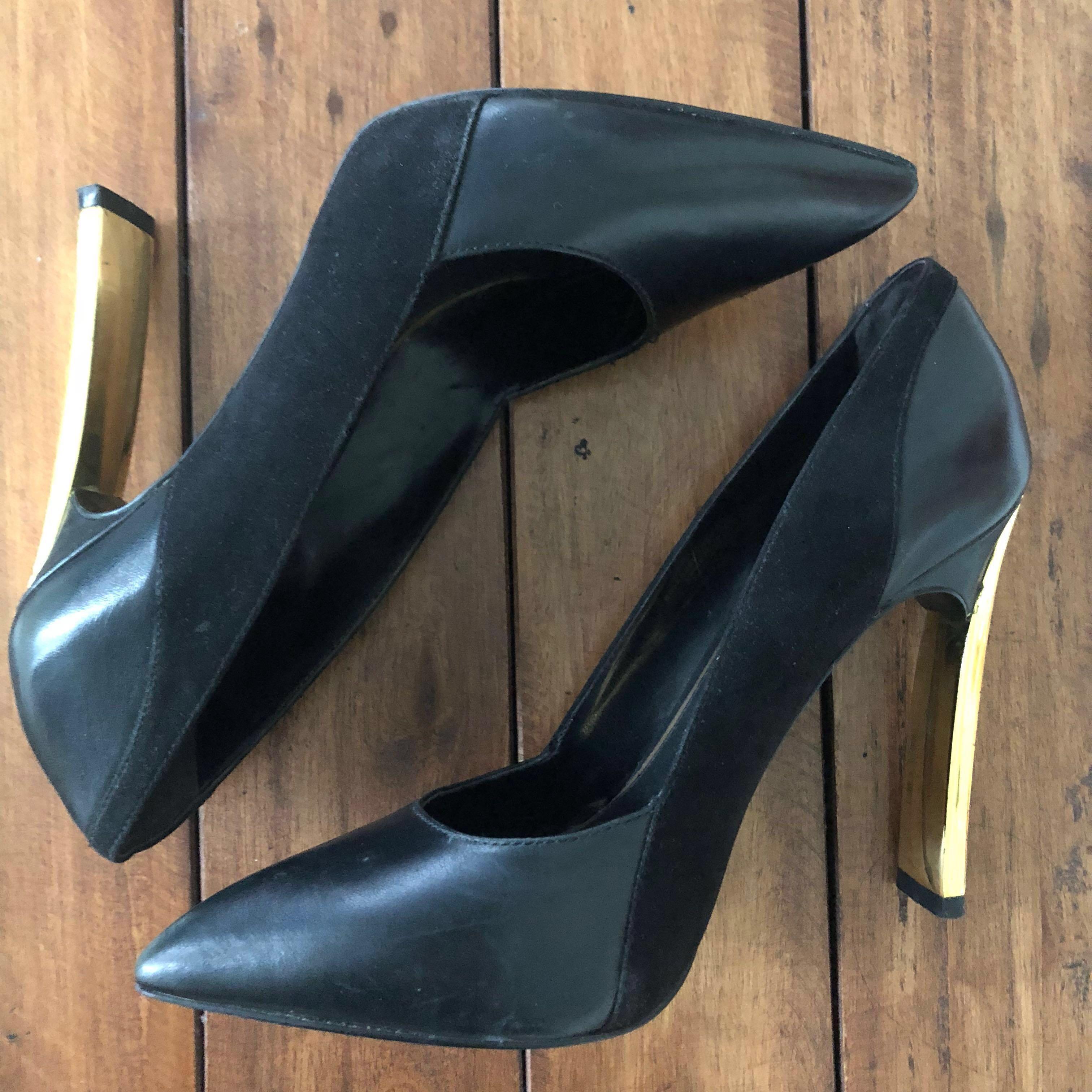 black pumps with gold heels