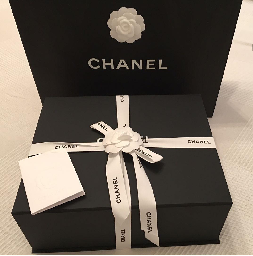 Large Chanel box. Includes large paper bag, carmelia flower, ribbon, chanel  receipt holder, air paper for stuffing bags