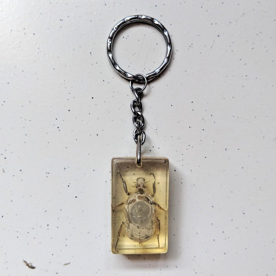 Bug keychain (Category: Religious Items) located in Singapore. Submitted by kimchipancakes (Listing ID 211135280, Image 1). Description: Some kind of insect acrylic keychain. Not too sure. Found it in storage, never used before. One side of the acrylic is rougher than the other side, I think it is part of the manufacturing process. Dimensions: 2.2cm x 3.6cm x 1.2cm Collect at Yew Tee MRT Keywords: Insect, beetle, bug.