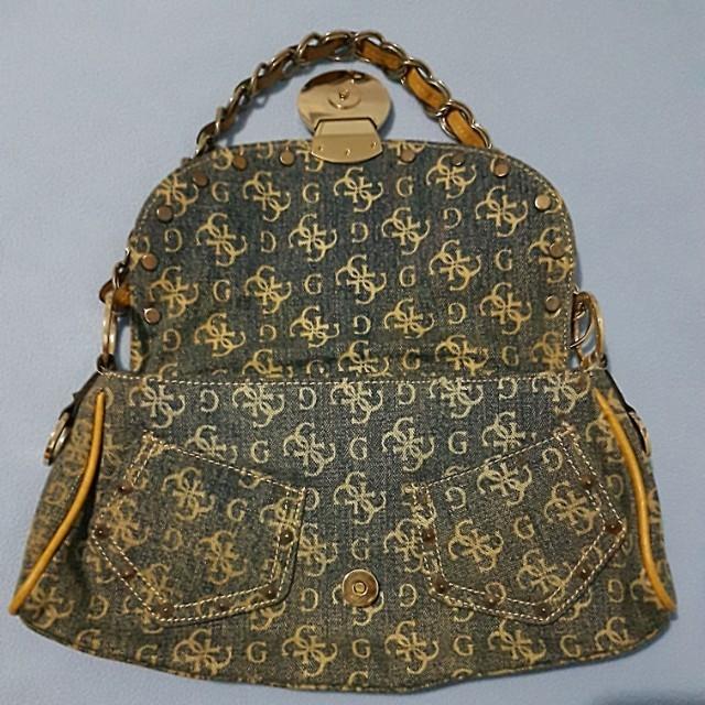 Guess Denim Bag (Category: Cross-body Bags) located in Paranaque City. Submitted by mamaalphaecho (Listing ID 211323555, Image 2). Description: FIXED PRICE = READ THE ENTIRE AD PRIOR TO INQUIRY. Click "READ MORE" = Used twice max then stored, hence the "cabinet" smell. Denim monogram material with faux leather accents and chain handle. Outer part may need cleaning but the inner part is in pristine condition. With two "pants" pockets in front and 