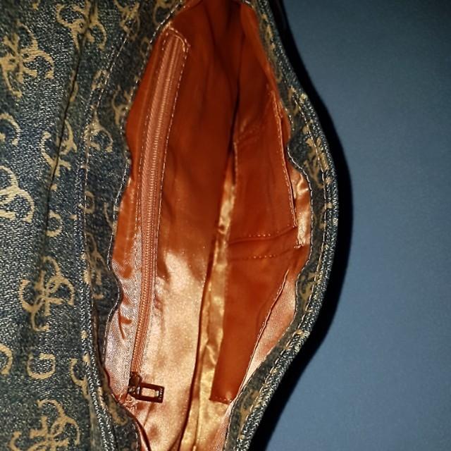 Guess Denim Bag (Category: Cross-body Bags) located in Paranaque City. Submitted by mamaalphaecho (Listing ID 211323555, Image 3). Description: FIXED PRICE = READ THE ENTIRE AD PRIOR TO INQUIRY. Click "READ MORE" = Used twice max then stored, hence the "cabinet" smell. Denim monogram material with faux leather accents and chain handle. Outer part may need cleaning but the inner part is in pristine condition. With two "pants" pockets in front and 