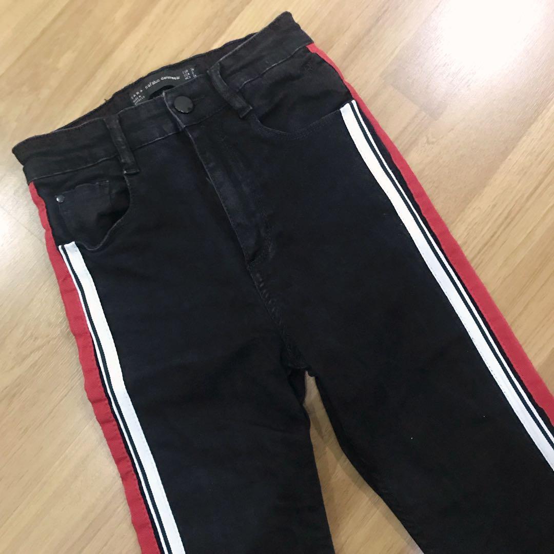 black jeans with red and white stripe