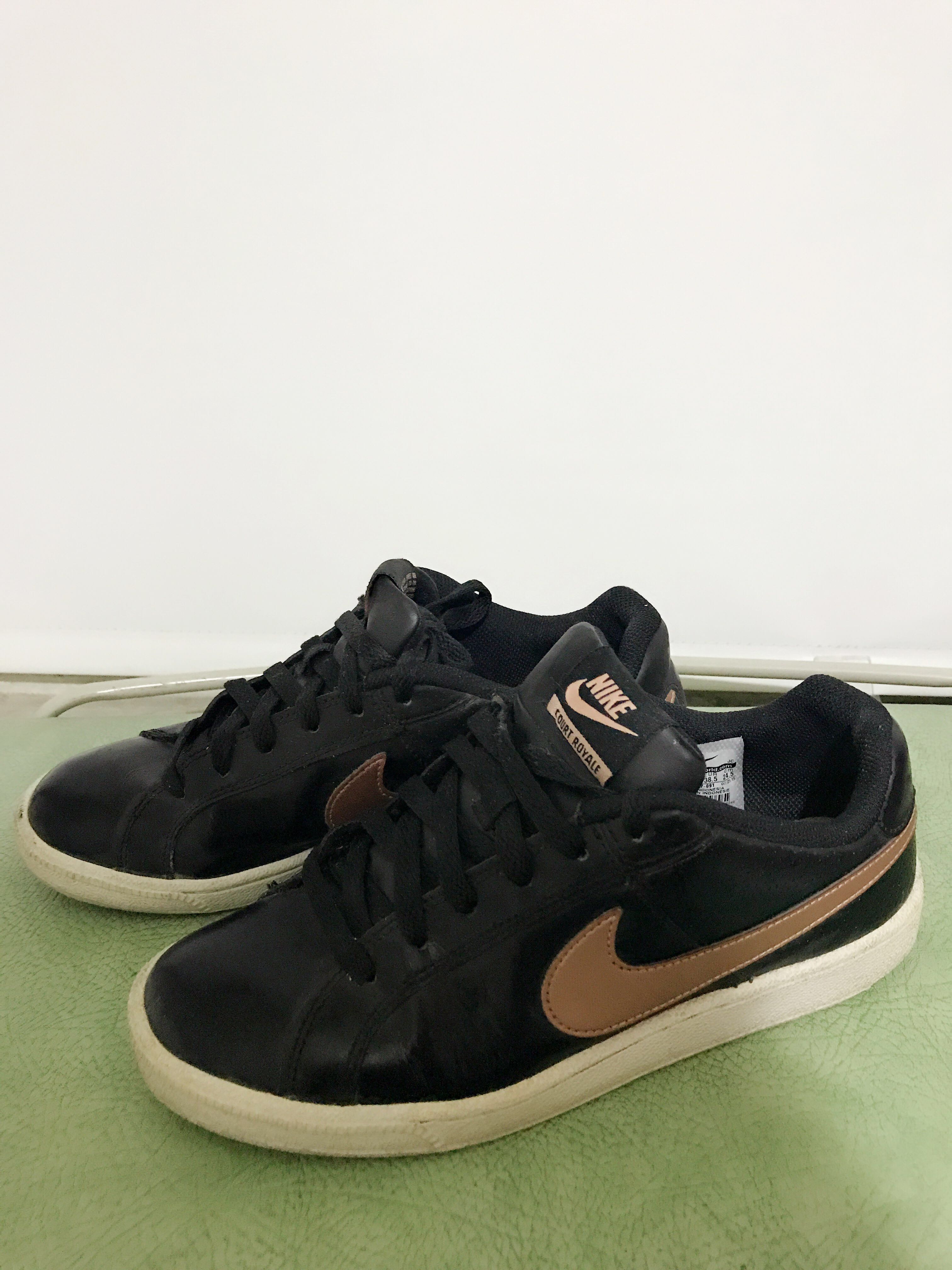 black nike shoes with gold tick