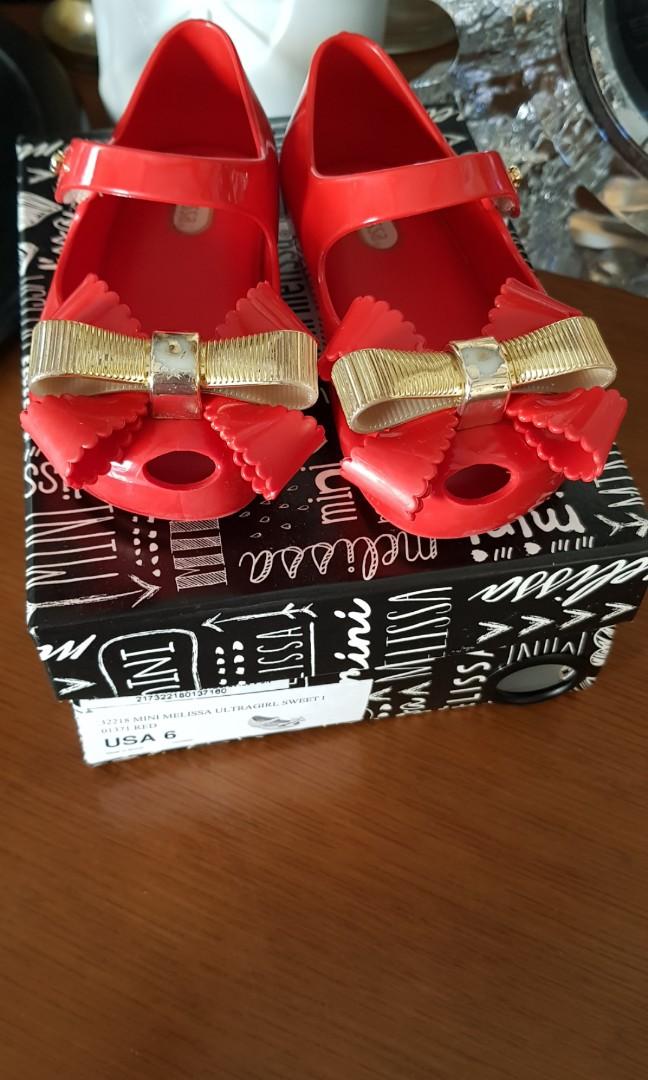 Mini melissa red shoes (Category: Babies & Kids Fashion) located in Urdaneta. Submitted by cristab12 (Listing ID 213484557, Image 1). Description: Preloved by my lo Size 6 9/10 condition Flaw: faded gold bow as shown in the picture but still very beautiful when worn Plus sf.