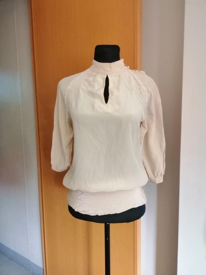 Nude Top (Category: Sleeveless) located in Taguig. Submitted by fruity_mint (Listing ID 214019548, Image 1). Description: High neck blouse with keyhole on front and cut on the back. Has zipper on the left side 3/4 sleeves.