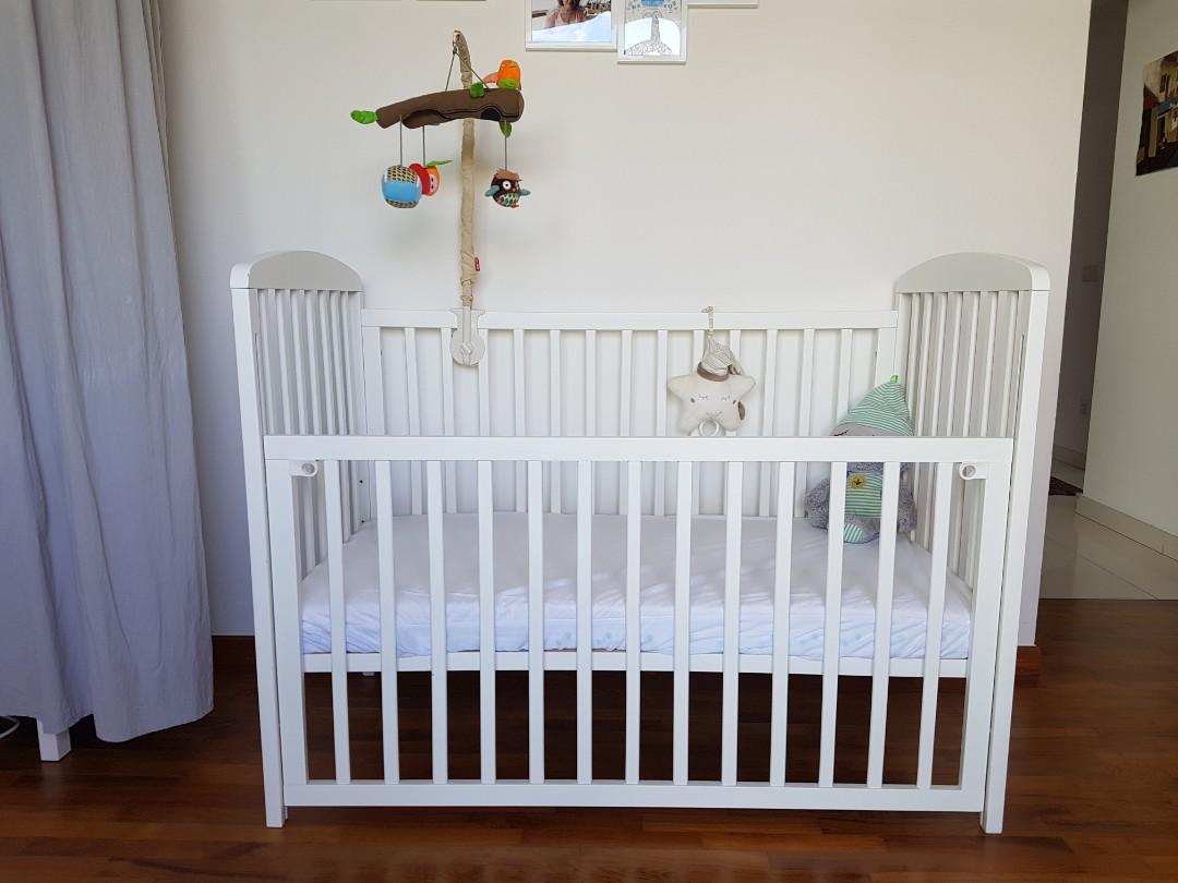 Baby cot with sliding side on rolls optional