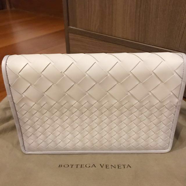 BOTTEGA VENETA Medium Woven White Clutch (Category: Luxury Bags & Wallets) located in Manila. Submitted by bagstagram (Listing ID 130187169, Image 1). Description: Bottega Veneta Montebello Intrecciato Woven Clutch Bag Color: white with hint of gray border Comes with BV dust bag, card and paper bag Height - 17 cm Width - 15 cm Depth- 4-5 cm.