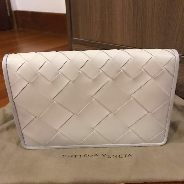 BOTTEGA VENETA Medium Woven White Clutch (Category: Luxury Bags & Wallets) located in Manila. Submitted by bagstagram (Listing ID 130187169, Image 2). Description: Bottega Veneta Montebello Intrecciato Woven Clutch Bag Color: white with hint of gray border Comes with BV dust bag, card and paper bag Height - 17 cm Width - 15 cm Depth- 4-5 cm.
