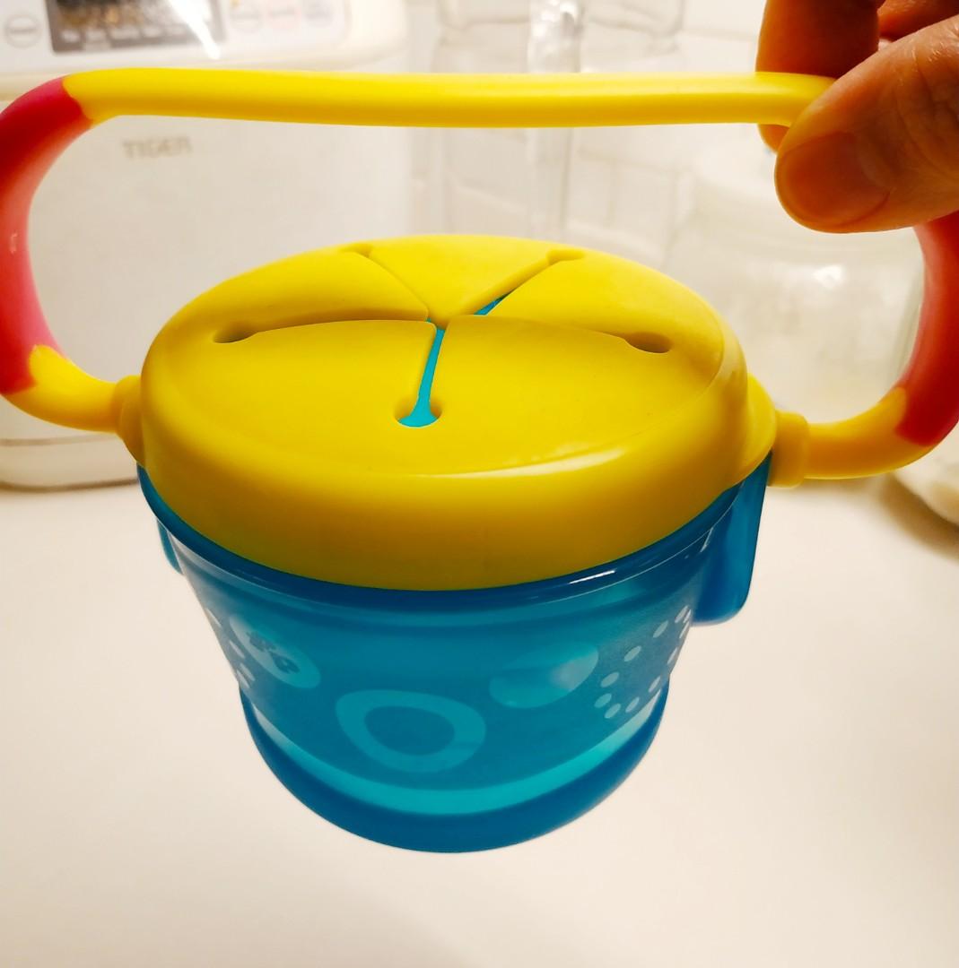 Fisher Price Tote Along Snack Cup (Category: Weaning & Toddler Feeding) located in Manila. Submitted by greatbabystuff (Listing ID 218690757, Image 1). Description: The Tote Along Snacker is the only Snacker that has a carrying handle for use on the go. Little ones will love carrying around the snacker and Mom can hang it on the stroller too. The flexible flap allows little hands to reach into the top but the flap design prevents spills and messe