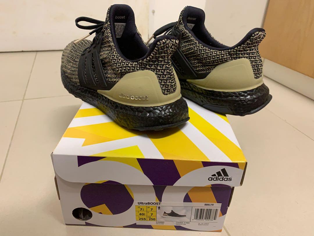 Ultra boost black raw gold discount