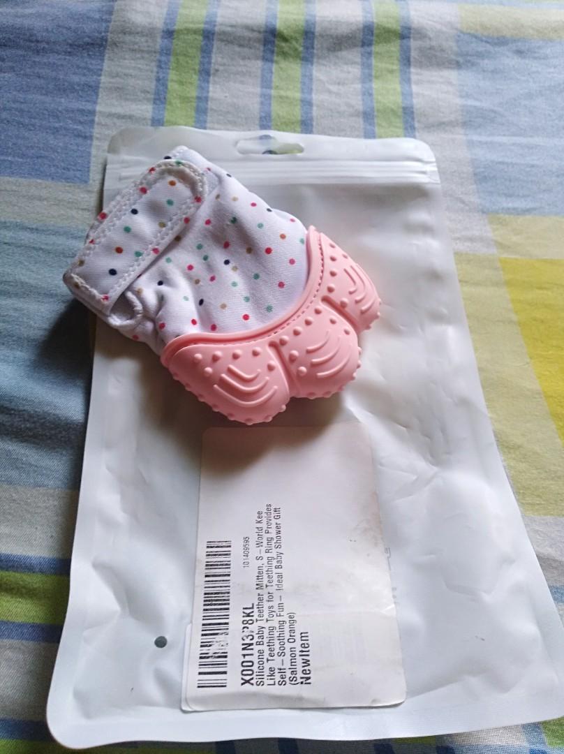 Silicone baby teether/mittens (Category: Weaning & Toddler Feeding) located in Manila. Submitted by kahelkloune (Listing ID 219242059, Image 2). Description: Brand new baby silicone mittens/teether. Salmon pink color.