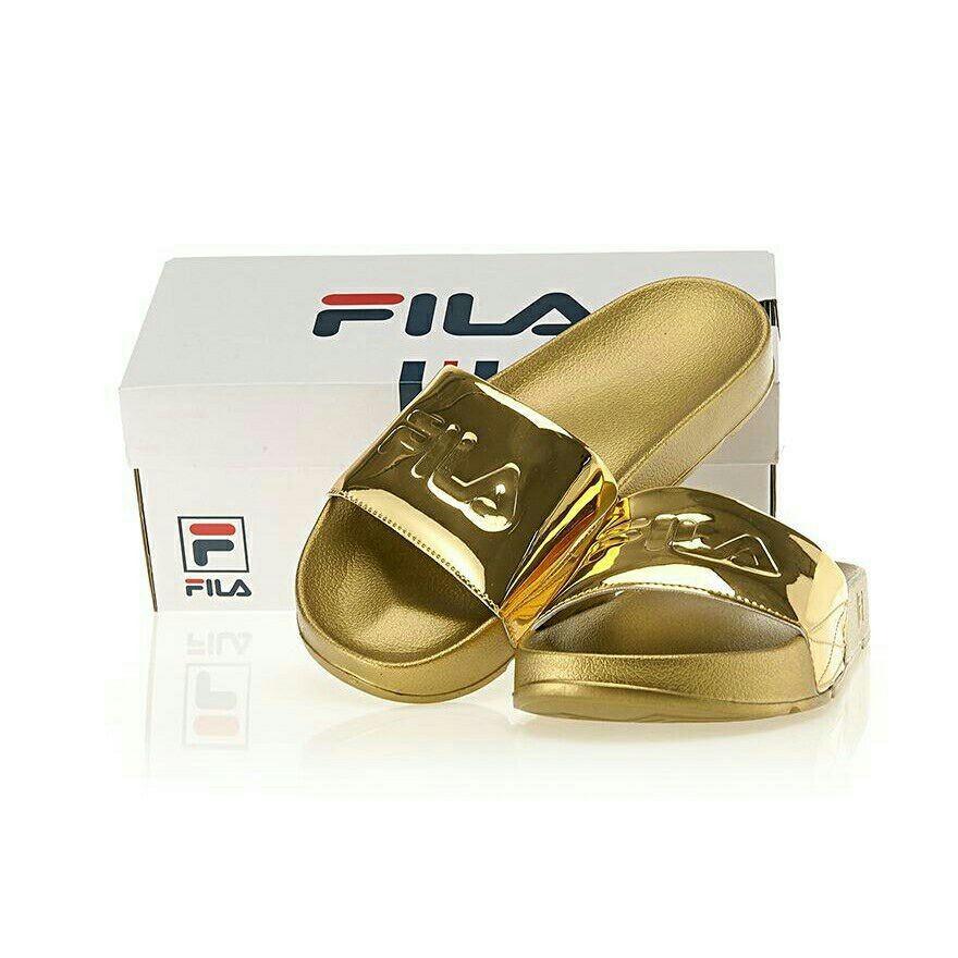 white and gold fila slides