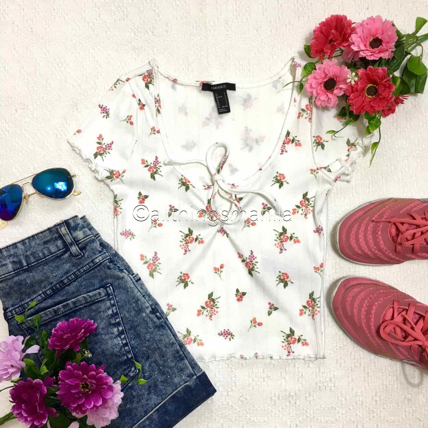 F21 Floral Self Tie Semi Crop Top (Category: Sleeveless) located in Quezon City. Submitted by allthingsmnl (Listing ID 222402429, Image 1). Description: Available in: S and M Brand new - new design ♥️ Super high quality ang fabric. DM me to see when worn photo. Final price posted. For sure buyers only. #aprilsale.