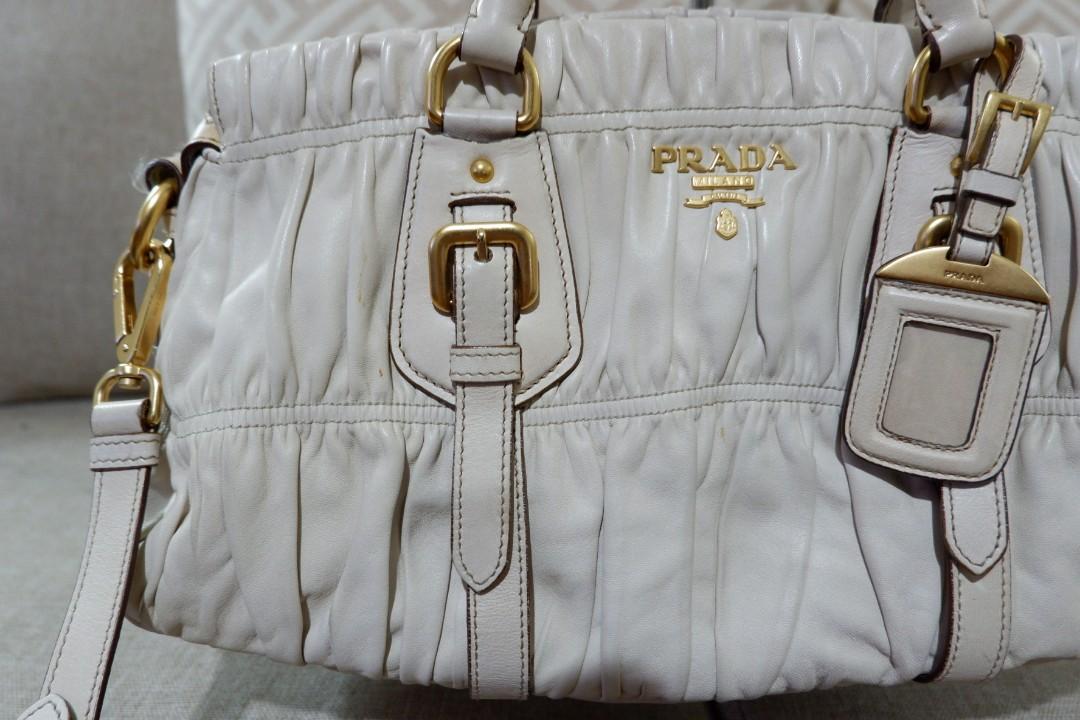Authentic Prada Gaufre Napa Ivory Gold Hardware (Category: Luxury Bags & Wallets) located in Makati City. Submitted by foukfouk (Listing ID 229930373, Image 2). Description: Authentic Prada Gaufre Napa Ivory Gold Hardware Very well loved Excellent condition. No damage. Some very little, almoat not obvious dirt on the body od the bag. Ivory Napa leather. 24k gold hardware. Almost no obvious dirt on the handle. Comes with shoulder strap, and sling 