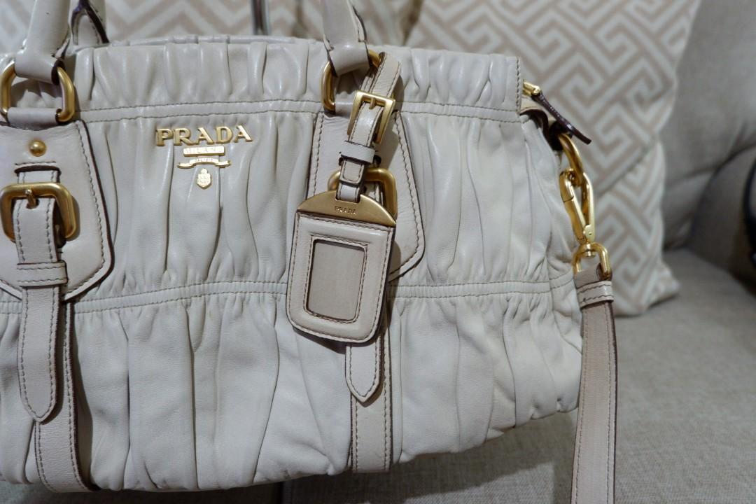 Authentic Prada Gaufre Napa Ivory Gold Hardware (Category: Luxury Bags & Wallets) located in Makati City. Submitted by foukfouk (Listing ID 229930373, Image 3). Description: Authentic Prada Gaufre Napa Ivory Gold Hardware Very well loved Excellent condition. No damage. Some very little, almoat not obvious dirt on the body od the bag. Ivory Napa leather. 24k gold hardware. Almost no obvious dirt on the handle. Comes with shoulder strap, and sling 
