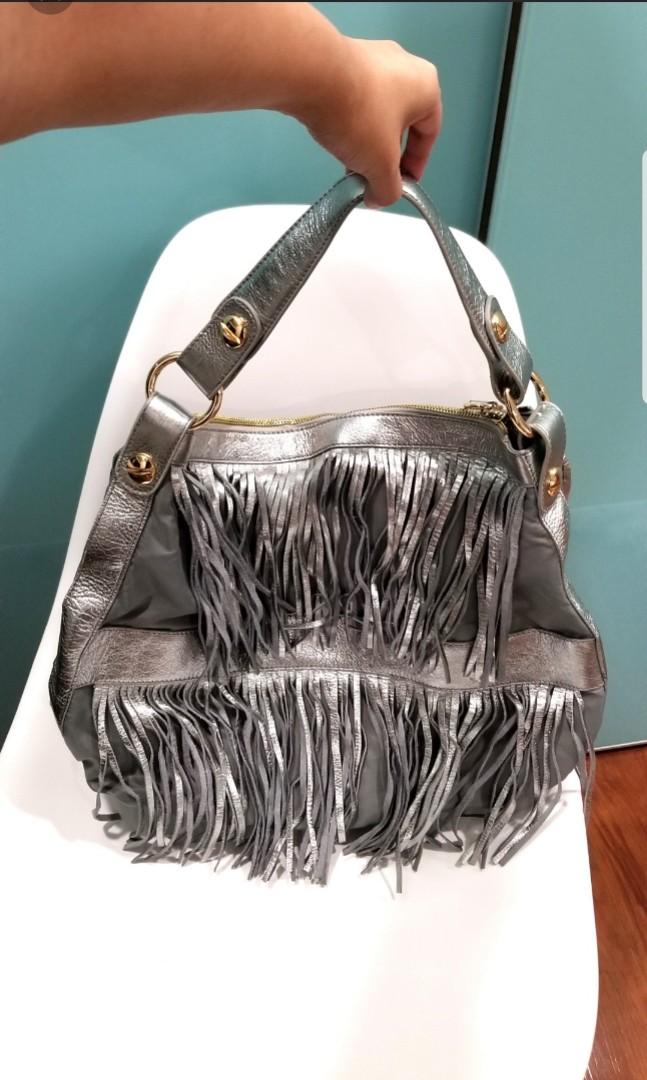 jessica silver fringe leather bag (Category: Cross-body Bags) located in Quezon City. Submitted by krista_closet (Listing ID 230073638, Image 1). Description: new kept in storage. material is mix of leather and fabric. dimensions: 16 x 13 inches.