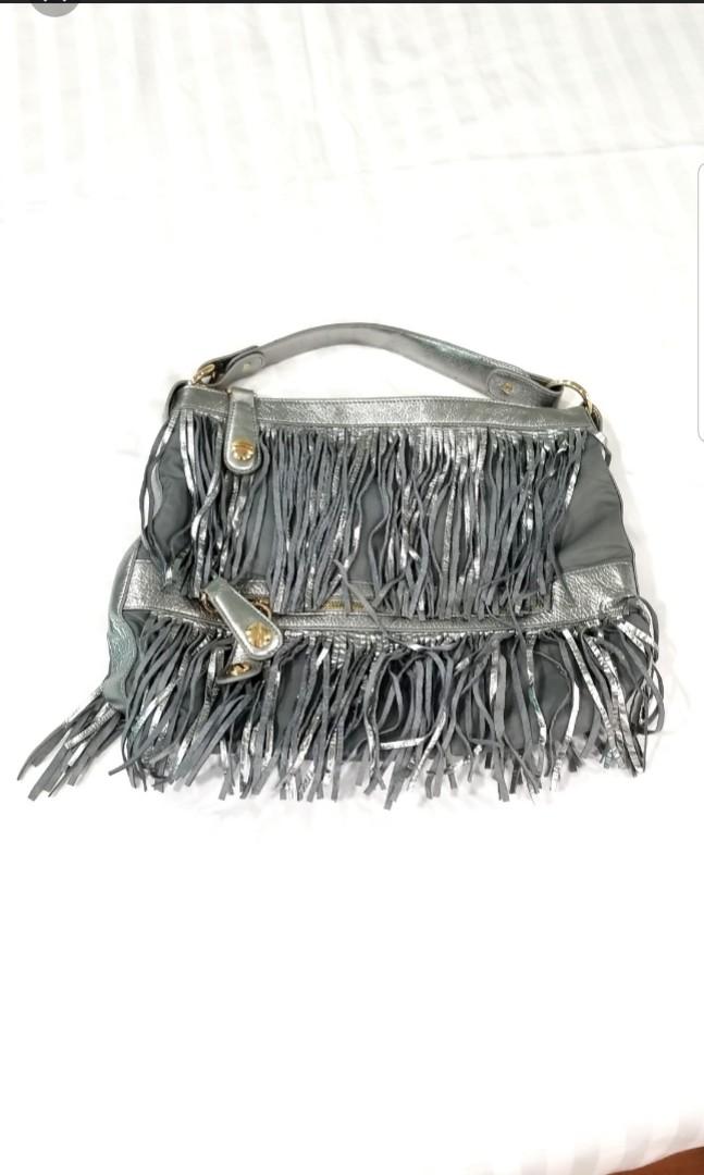 jessica silver fringe leather bag (Category: Cross-body Bags) located in Quezon City. Submitted by krista_closet (Listing ID 230073638, Image 3). Description: new kept in storage. material is mix of leather and fabric. dimensions: 16 x 13 inches.