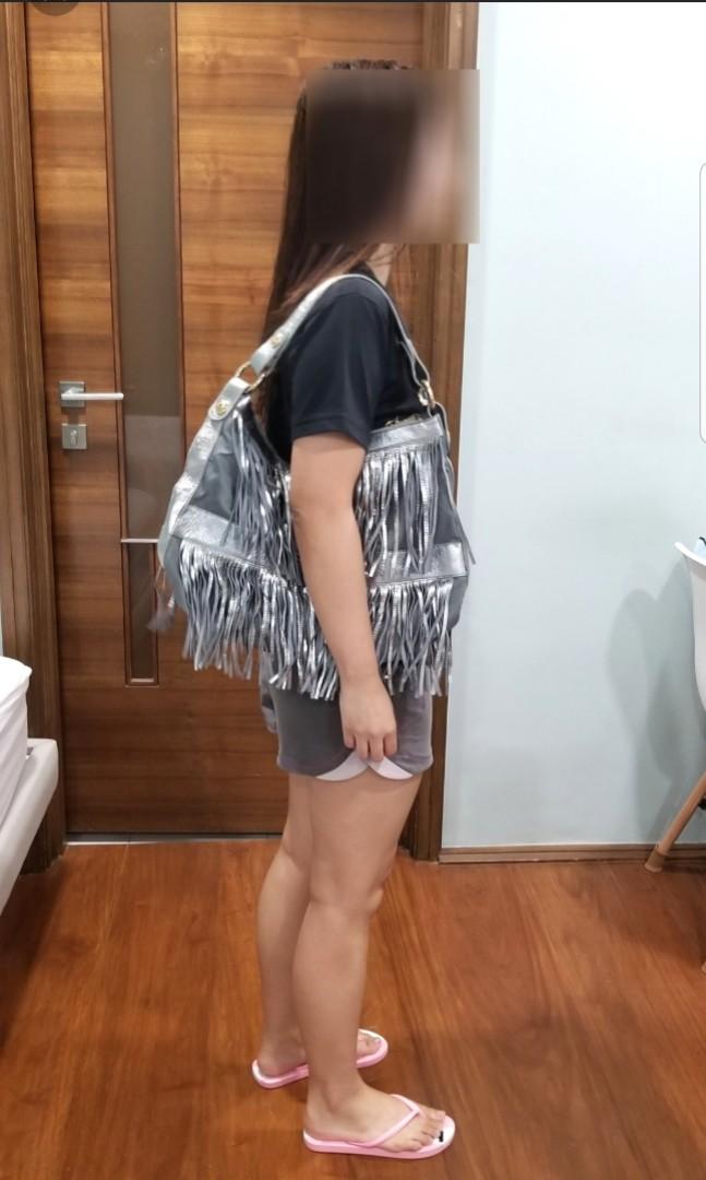 jessica silver fringe leather bag (Category: Cross-body Bags) located in Quezon City. Submitted by krista_closet (Listing ID 230073638, Image 2). Description: new kept in storage. material is mix of leather and fabric. dimensions: 16 x 13 inches.
