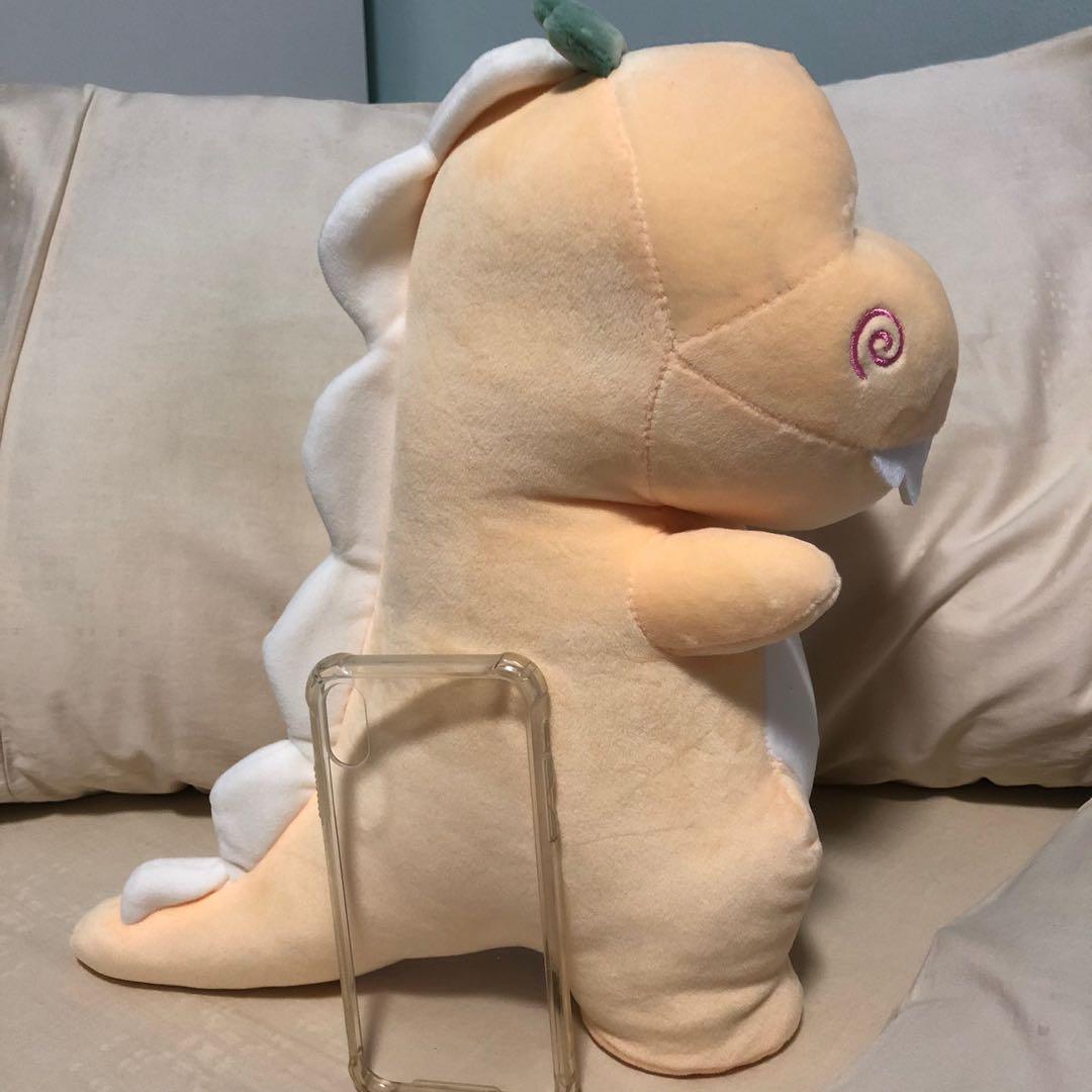 yellow stuffed dinosaur