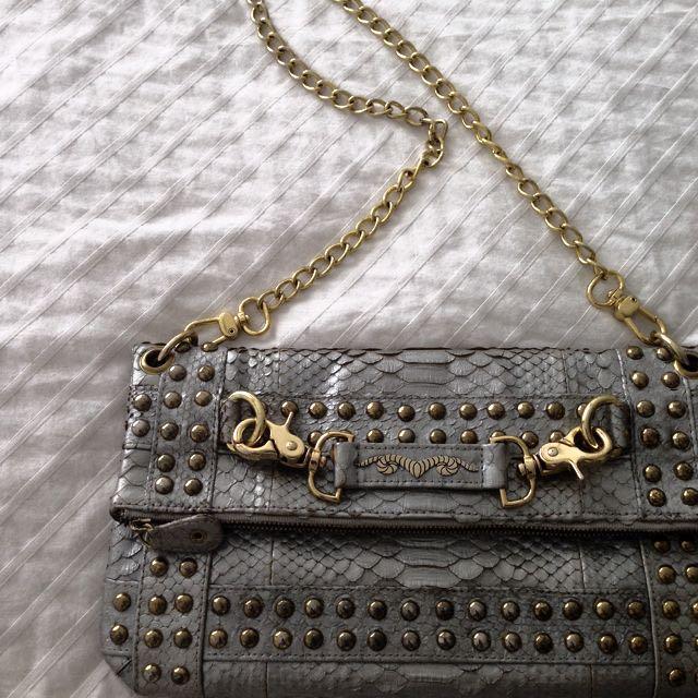 Disco Metallic Silver Python Clutch (Category: Bags & Wallets) located in Singapore. Submitted by ladyh82 (Listing ID 5666015, Image 1). Description: Made with genuine python skin. With soft calf leather lining and 18k gold plated Ares logo. Sling and clutch handbag for the real disco dancers! X.