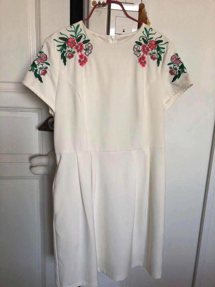 white dress with embroidered flowers
