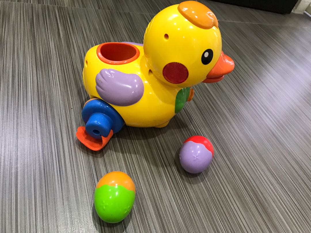 Egg laying duck toy top