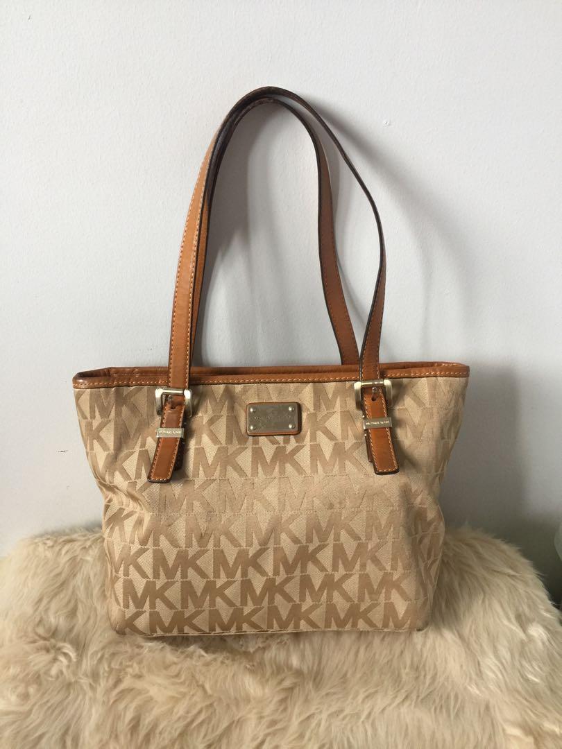 Pre-loved Michael Kors Tote Bag (Category: Cross-body Bags) located in Pasig City. Submitted by thrillsofthrift (Listing ID 235727097, Image 1). Description: Pre-loved Michael Kors Tote Bag Material: Canvas with leather zip closure and handle Color: Tan Measurements: 13in W x 9in H x 5in D Strap Drop: 9in Pre-loved Michael Kors in functional condition but has worn signs. Kindly check photos for closer look. #michaelkors #MK #tote #bag #shoulder #