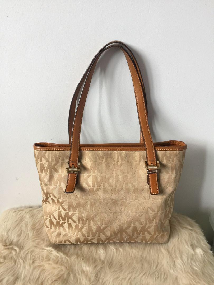 Pre-loved Michael Kors Tote Bag (Category: Cross-body Bags) located in Pasig City. Submitted by thrillsofthrift (Listing ID 235727097, Image 2). Description: Pre-loved Michael Kors Tote Bag Material: Canvas with leather zip closure and handle Color: Tan Measurements: 13in W x 9in H x 5in D Strap Drop: 9in Pre-loved Michael Kors in functional condition but has worn signs. Kindly check photos for closer look. #michaelkors #MK #tote #bag #shoulder #