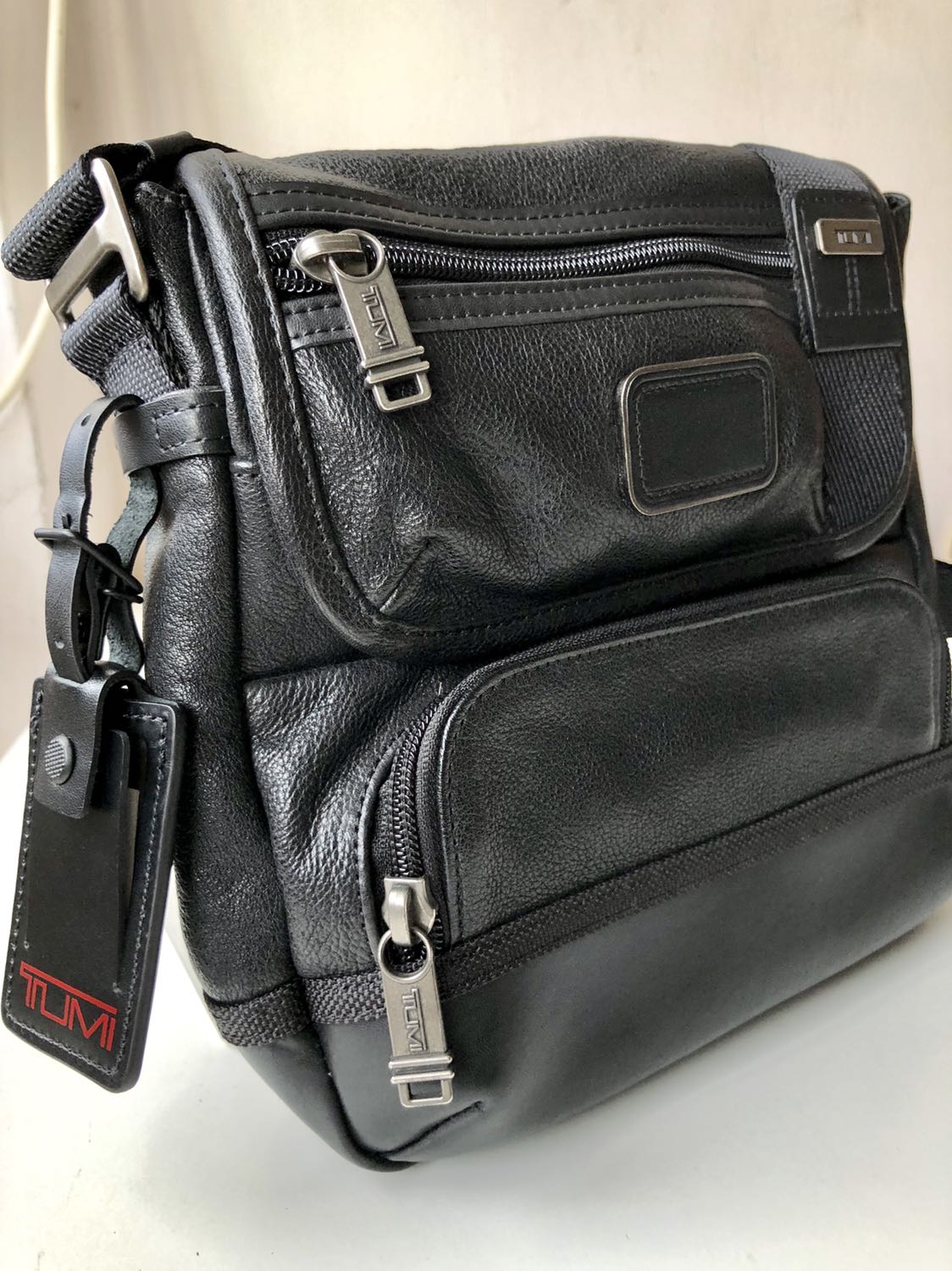 tumi leather sling bag