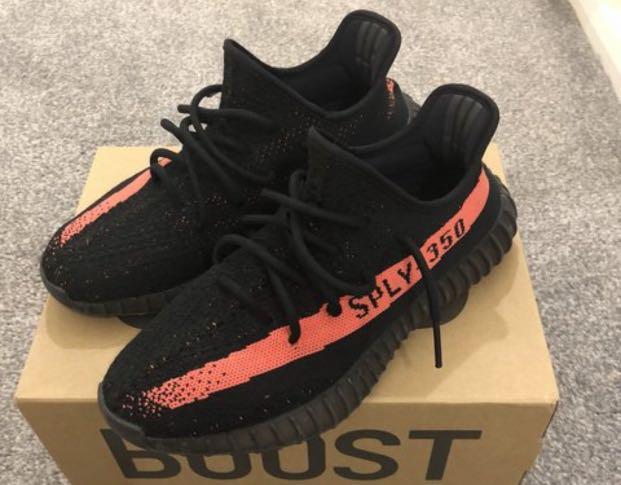 black yeezys with orange stripe