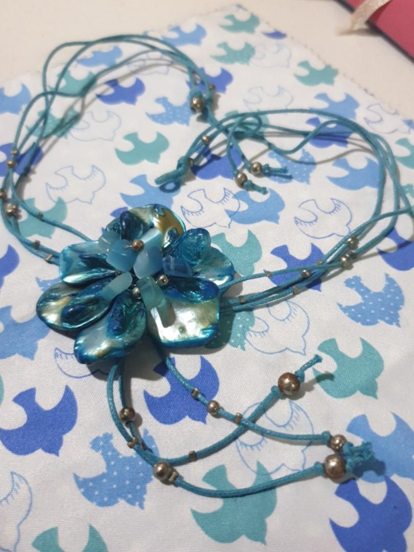 Turquoise-colored Flower Necklace (Category: Necklaces) located in Quezon City. Submitted by daaaaane (Listing ID 241215315, Image 2). Description: An aqua blue necklace featuring a six-petal flower with a mother-of-pearl finish. Secured by a loop and a silver bead on the back. The flower is held together by silver wires threaded through each petal. I might've worn this for my debut. Might've. Di ko na 100% maalala eh. 😂😂😂.