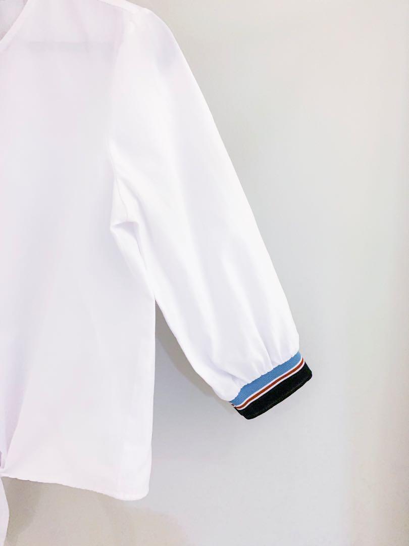 Stradivarius Front Tie White Top (Category: Others Tops) located in Muntinlupa City. Submitted by andreadaniela (Listing ID 241895029, Image 2). Description: Great condition! White quarter sleeved too with red, white, & blue details and front tie. (No when worn photos at the moment).