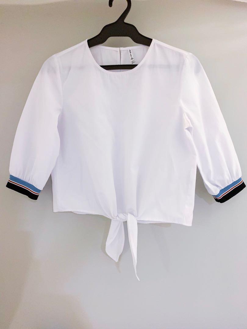 Stradivarius Front Tie White Top (Category: Others Tops) located in Muntinlupa City. Submitted by andreadaniela (Listing ID 241895029, Image 1). Description: Great condition! White quarter sleeved too with red, white, & blue details and front tie. (No when worn photos at the moment).