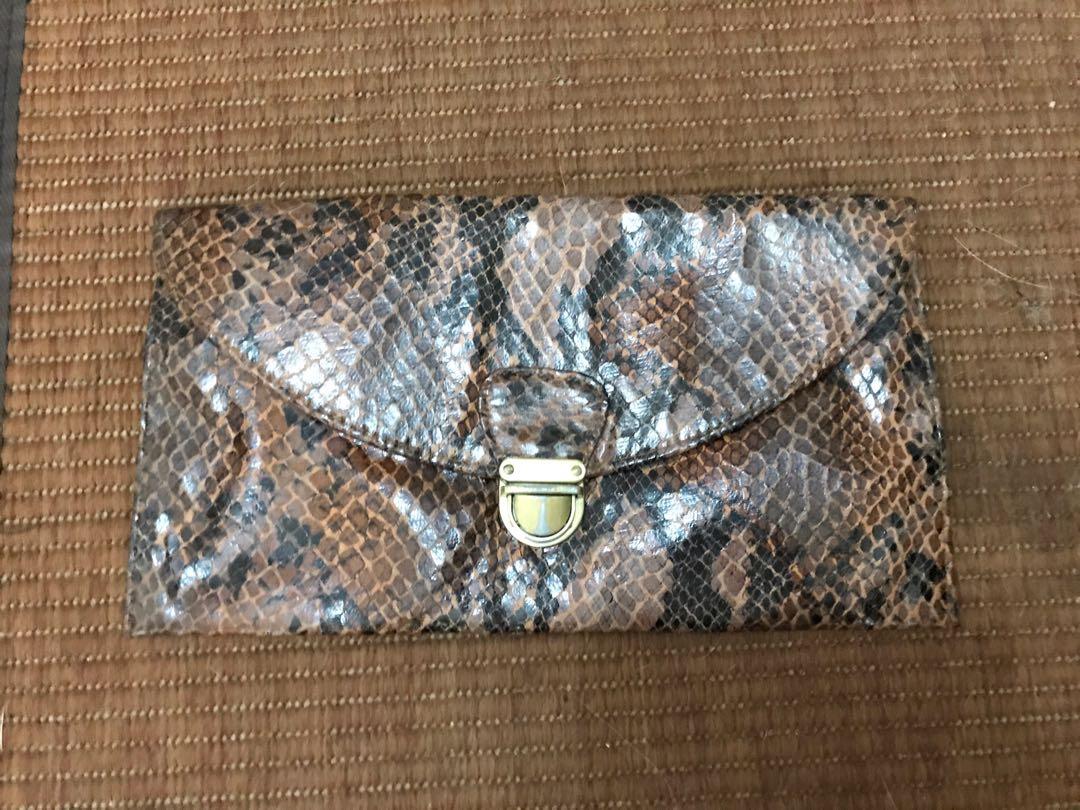 Clutch bag (Category: Clutches) located in Pasig City. Submitted by misstthings (Listing ID 243328122, Image 1). Description: Pre Loved WWW Clutch Brown snakeskin Good condition Mop: BPI or BDO Shipping c/o buyer OR Meet up: Capitol commons or Taft ave PIOG 😊 .