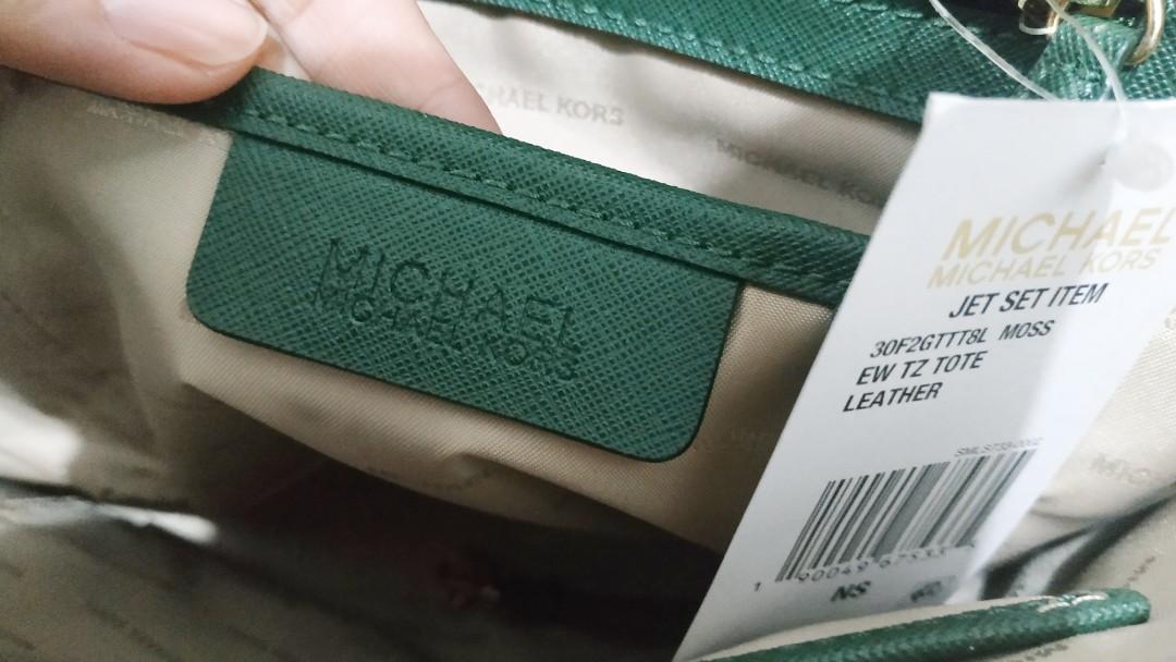 MK Jet Set Tote Bag Moss Green (Category: Luxury Bags & Wallets) located in Manila. Submitted by thecluttershop_2018 (Listing ID 243289344, Image 3). Description: Bought from the US AUTHENTIC WITH CARD AND TAG With faded 3 letters on the logo and light scratches on the bag feet due to storage. Logo can be re-electroplated by Dr. Leather (I already asked for a quotation, it's 750 pesos) With tag, plain dustbag and bag puff. #hbdcarousell.