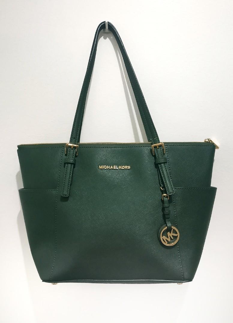 MK Jet Set Tote Bag Moss Green (Category: Luxury Bags & Wallets) located in Manila. Submitted by thecluttershop_2018 (Listing ID 243289344, Image 1). Description: Bought from the US AUTHENTIC WITH CARD AND TAG With faded 3 letters on the logo and light scratches on the bag feet due to storage. Logo can be re-electroplated by Dr. Leather (I already asked for a quotation, it's 750 pesos) With tag, plain dustbag and bag puff. #hbdcarousell.