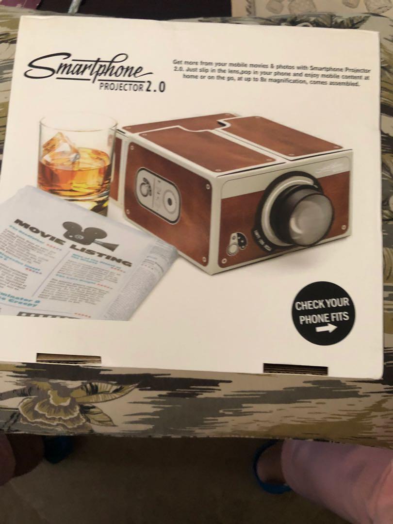 Smartphone Projector 2.0 (Category: Projectors) located in Manila. Submitted by chelseaaudrey (Listing ID 244792027, Image 2). Description: Smartphone Projector 2.0 comes with a soft matt laminate finish and silver foil accents and makes the perfect gift for any gadget lover. Whether it's for Christmas, a birthday or just because – Smartphone Projector 2.0 is a fun gift any time of year! Brand new and boxed Fresh from US BOX.
