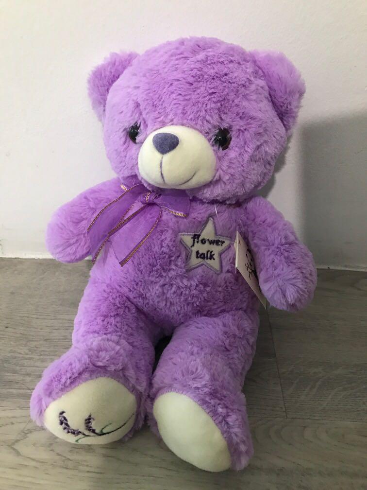 purple teddy bear with flowers