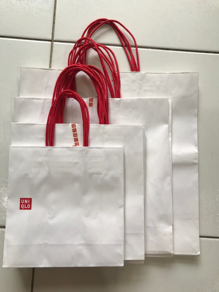 Person Carrying a Uniqlo Paper Bag  Free Stock Photo