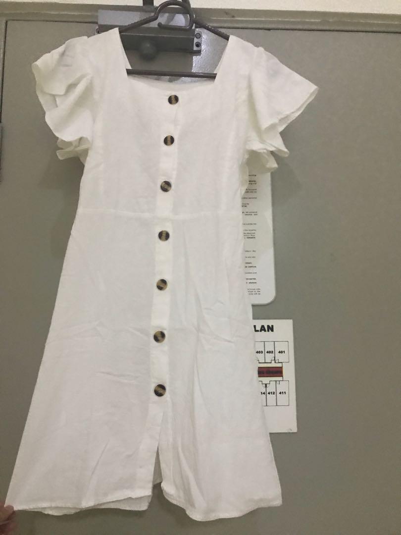 White dress (Category: Dresses) located in Manila. Submitted by declutter_____ (Listing ID 247088386, Image 2). Description: This gorgeous dress is perfect for casual days. It highlights a frilled sleeve and functional buttons. Product details - Cotton linen - Relaxed fit - Frilled sleeves - Functional buttons Size guide Freesize: fits extra small to medium Bust: 30 to 34 inches Waist: 24 to 28 inches .